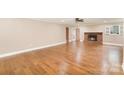 Spacious living room with hardwood floors, fireplace, and natural light at 6300 Morehead Rd, Harrisburg, NC 28075