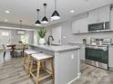 Modern kitchen featuring granite countertops, stainless steel appliances, and stylish pendant lighting at 6310 Forney Hill Rd, Denver, NC 28037