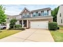 Two-story home with brick and gray siding, a two-car garage, well-maintained lawn and manicured front yard at 6961 Liverpool Ct, Fort Mill, SC 29707