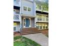A welcoming front entrance with a blue door and well-maintained landscaping at 9541 Shannon Green Dr, Charlotte, NC 28213