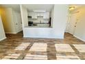 Open living space with a view of the kitchen and wood-style flooring at 9541 Shannon Green Dr, Charlotte, NC 28213