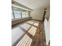 Bright living room featuring large windows and wood-style flooring at 9541 Shannon Green Dr, Charlotte, NC 28213