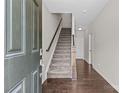 Welcoming entryway with hardwood floors, staircase, and neutral walls at 9620 Ainslie Downs St, Charlotte, NC 28273