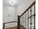 Foyer featuring wood floors, a staircase with wood and iron railings, and white walls at 9620 Ainslie Downs St, Charlotte, NC 28273