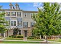 Attractive multi-colored townhome featuring a stone facade, lush lawn, and mature trees at 9620 Ainslie Downs St, Charlotte, NC 28273