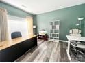 Inviting home office featuring modern décor, wood-look floors, and ample natural light at 9792 Ravenscroft Nw Ln, Concord, NC 28027