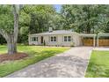 Brick ranch home with large driveway, carport, and landscaped yard at 1006 Home Trl, Gastonia, NC 28052