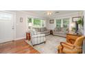 Bright living room with hardwood floors, area rug, and neutral decor at 1006 Home Trl, Gastonia, NC 28052