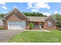 Lovely brick home with an attached garage and green lawn at 1011 Atherstone Nw St, Conover, NC 28613
