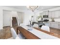 Dining area with modern chandelier, adjacent to kitchen with granite countertops and stainless appliances at 1108 Millbridge Rd # 110, Belmont, NC 28012