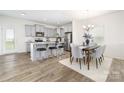 Modern kitchen with stainless steel appliances, gray cabinetry, granite countertops, and a dining area at 1108 Millbridge Rd # 110, Belmont, NC 28012