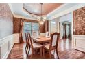 Elegant dining room with hardwood floors, decorative wallpaper, and a chandelier at 1220 Elrond Nw Dr, Charlotte, NC 28269