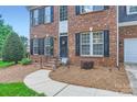 Inviting front entrance with brick steps, iron railing, and well-kept landscaping at 1220 Elrond Nw Dr, Charlotte, NC 28269