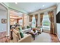 Bright living room with neutral colors, plush seating, and large windows at 1220 Elrond Nw Dr, Charlotte, NC 28269