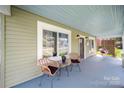 Charming front porch with wicker chairs, perfect for relaxing and enjoying the view at 124 Marion St, Clover, SC 29710