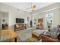 Bright living room with hardwood floors, a ceiling fan, and abundant natural light from large windows at 1315 East Blvd # 203, Charlotte, NC 28203