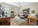 Spacious living room featuring hardwood floors and large windows, offering ample natural light at 1315 East Blvd # 203, Charlotte, NC 28203