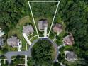 Aerial view of the home, showcasing its placement within a lush, tree-lined cul-de-sac neighborhood at 14010 Promenade Dr, Huntersville, NC 28078
