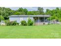 Cozy single-story home featuring a covered porch and convenient ramp access, surrounded by lush greenery and a well-kept lawn at 1406 Old Puckett Pl # 14, York, SC 29745