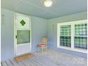 Covered porch featuring a cozy sitting area with a chair and a view through the window at 1406 Old Puckett Pl # 14, York, SC 29745