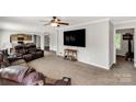 Open concept living room with a brown leather couch and neutral carpet at 159 Blackmon Pond Rd, Lancaster, SC 29720