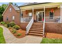 Inviting front porch adorned with festive decor and complemented by well-maintained landscaping at 159 Forest Abbey Ln, China Grove, NC 28023