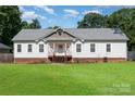 Traditional white home with inviting front porch, complemented by lush green lawn at 1593 Bloomfield Rd, Rock Hill, SC 29732