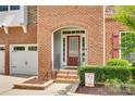 Close-up of the front door with a brick archway and decorative shrubbery at 169 Halifax Dr, Fort Mill, SC 29707