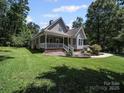 Charming two-story home with a welcoming front porch and a spacious front lawn at 179 Delwood Ct, Mount Gilead, NC 27371