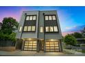 This modern home offers a sleek design with a two-car garage, clean lines, and ample window light at 1933 W Trade St, Charlotte, NC 28216