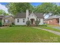 A well-maintained home with a brick chimney, manicured lawn, and charming curb appeal at 2130 Chesterfield Ave, Charlotte, NC 28205