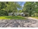 Charming single-story home with a well-maintained lawn, covered carport, and mature trees at 2222 19Th Ne Ave, Hickory, NC 28601