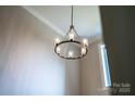 Elegant modern chandelier with glass shades and bronze finish, adding style to the home's interior at 240 Mark Ryan Ln, Dallas, NC 28034