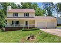 Charming two-story home with a cozy front porch and a well-maintained lawn at 308 Home Rd, Salisbury, NC 28147