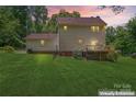 Expansive backyard featuring a spacious wooden deck, perfect for outdoor entertaining at 308 Home Rd, Salisbury, NC 28147