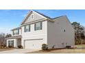 Side view of a two-story home with a gray exterior and a two-car garage at 4060 Beacon Ave # 148, Monroe, NC 28110