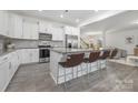 Bright kitchen with white cabinets, stainless appliances, and an island with seating at 4060 Beacon Ave # 148, Monroe, NC 28110