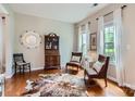 Bright living room featuring hardwood floors, neutral walls, and abundant natural light through large windows at 5056 Crandon Rd, Fort Mill, SC 29707
