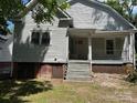 View of home's back exterior featuring a small porch and backyard at 517 Western Ave, Statesville, NC 28677