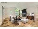 Living room with fireplace, hardwood floors, and a modern and inviting design, virtually staged at 5817 Rocky Mount Ct, Charlotte, NC 28214