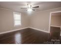 Bright living room with beautiful dark wood floors, neutral walls, ceiling fan, and ample natural light at 601 N Johnson St, Monroe, NC 28112