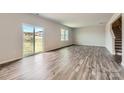 Bright living room featuring stylish floors and a sliding glass door to outdoor space at 6331 Fairfax Ct, Maiden, NC 28650