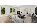 Bright living room features a fireplace, and is decorated with modern furniture and light-colored walls at 6340 Green Vista Ct, Charlotte, NC 28212
