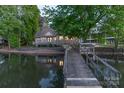 Charming lakefront home boasts a wooden dock and waterfront views, perfect for serene living at 639 Panther Point Trl, Richfield, NC 28137
