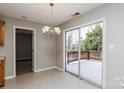 Open dining room with sliding glass doors to the deck and stylish chandelier at 676 Rebecca Jane Dr, Mooresville, NC 28115