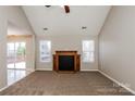 Inviting living room featuring a cozy fireplace, carpeted floors and ample natural light at 676 Rebecca Jane Dr, Mooresville, NC 28115