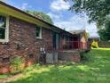 Exterior back of home with brick patio featuring air conditioning and lush lawn at 715 Sunridge Dr, Lincolnton, NC 28092