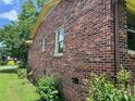 Exterior side view showing brick facade, windows, and well maintained lawn at 715 Sunridge Dr, Lincolnton, NC 28092