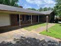 Classic brick home featuring a covered porch and a spacious two-car garage at 715 Sunridge Dr, Lincolnton, NC 28092