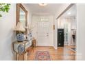 Bright foyer featuring hardwood floors, elegant console table, and a beautiful chandelier at 935 Trentle Ct, Charlotte, NC 28211